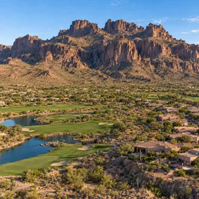 Aerial drone view of a desert golf course in Gold Canyon, Arizona, set against the Superstition Mountains.